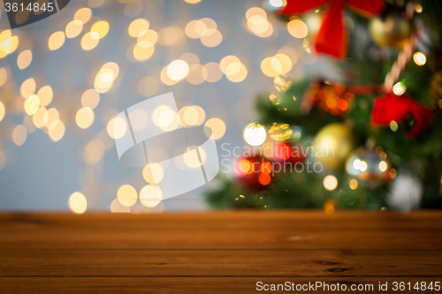 Image of empty wooden surface over christmas tree lights