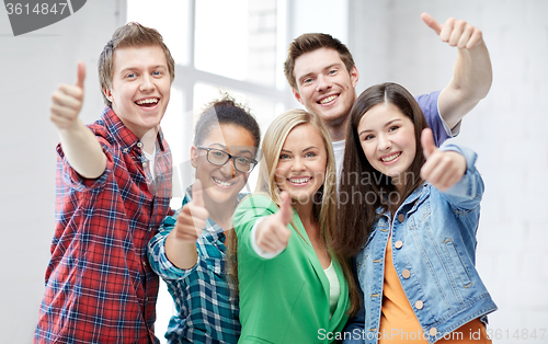 Image of group of happy students showing thumbs up