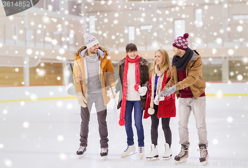 Image of happy friends on skating rink