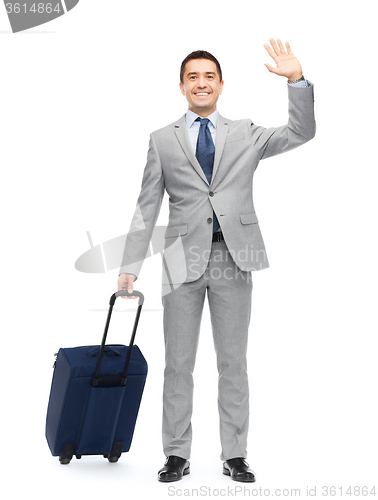 Image of happy businessman in suit with travel bag
