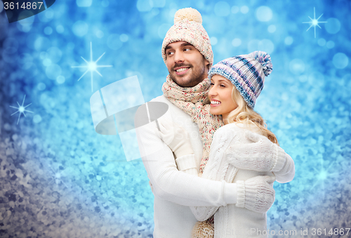 Image of smiling couple in winter clothes hugging