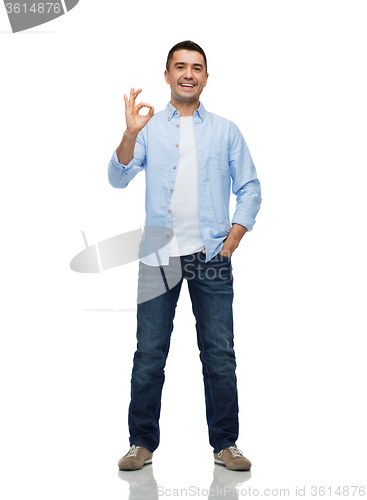 Image of smiling man showing ok hand sign
