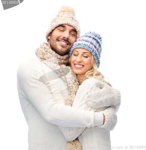 Image of smiling couple in winter clothes hugging