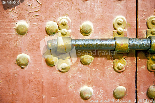 Image of brown  morocco in   the old wood    and rusty safe padlock 