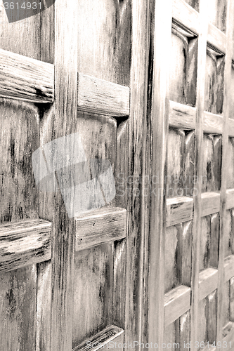 Image of home texture of a brown antique wooden old door in italy   europ