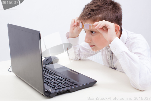 Image of Boy using his laptop computer