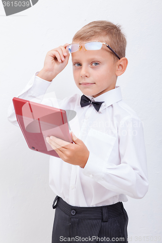 Image of Portrait of teen boy with calculator on white background