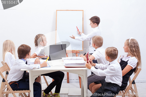 Image of The group of teenagers sitting in a business meeting