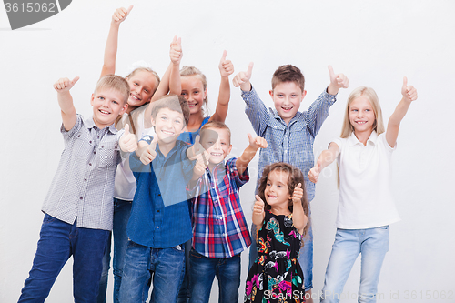 Image of The smiling teenagers showing okay sign on white 