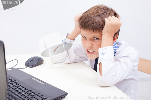 Image of Boy using his laptop computer
