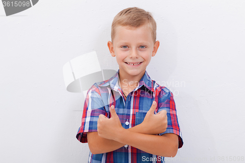 Image of Portrait of happy boy showing thumbs up gesture