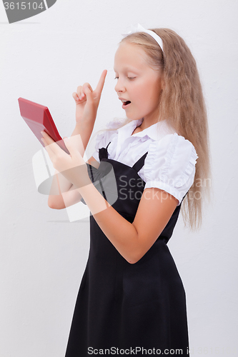 Image of Portrait of teen girl with calculator on white background