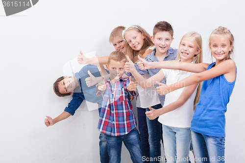 Image of The smiling teenagers showing okay sign on white 