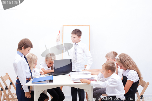 Image of The group of teenagers sitting in a business meeting