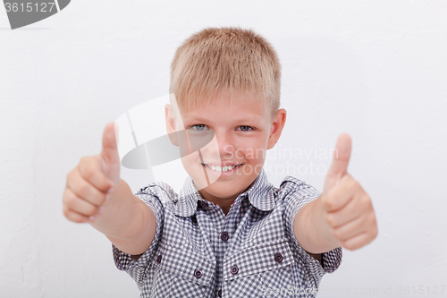 Image of Portrait of happy boy showing thumbs up gesture