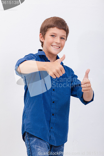 Image of Portrait of happy boy showing thumbs up gesture