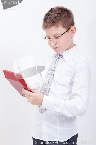 Image of Portrait of teen boy with calculator on white background