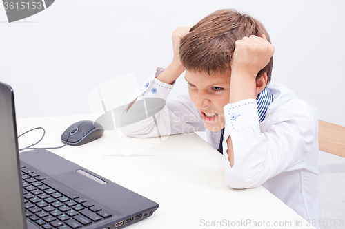 Image of Boy using his laptop computer