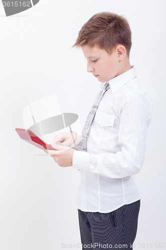 Image of Portrait of teen boy with calculator on white background