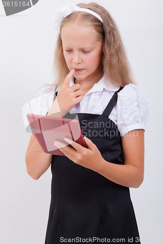 Image of Portrait of teen girl with calculator on white background