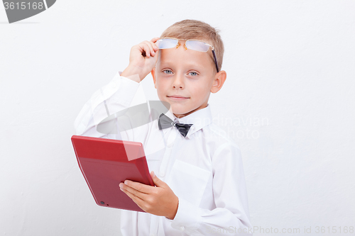 Image of Portrait of teen boy with calculator on white background