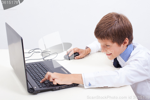 Image of Boy using his laptop computer