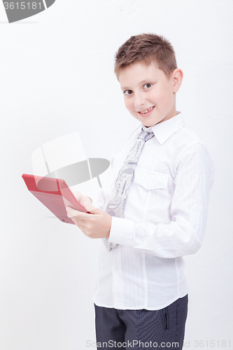 Image of Portrait of teen boy with calculator on white background