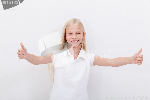 Image of Portrait of a beautiful girl showing thumbs up on white