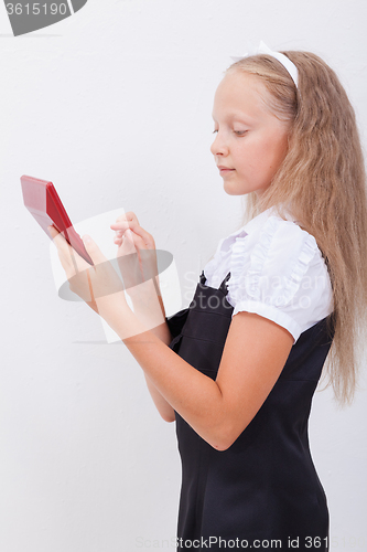 Image of Portrait of teen girl with calculator on white background