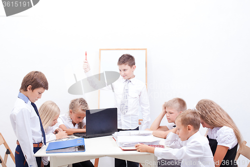 Image of The group of teenagers sitting in a business meeting