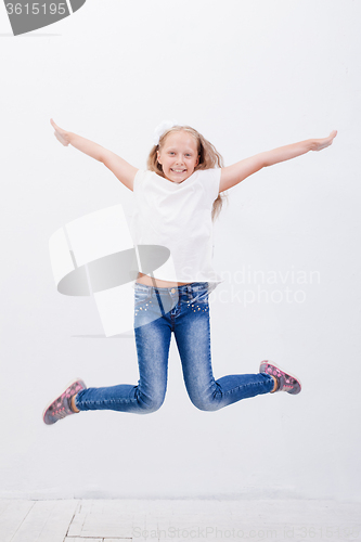 Image of  happy young girl jumping  on white background