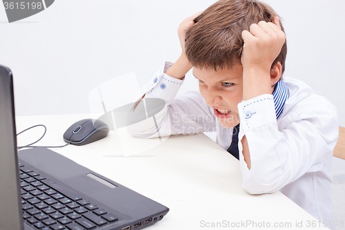 Image of Boy using his laptop computer