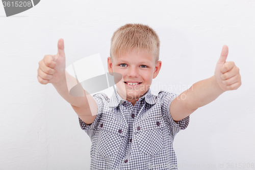 Image of Portrait of happy boy showing thumbs up gesture