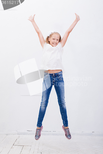 Image of  happy young girl jumping  on white background