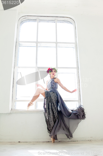 Image of The beautiful ballerina posing in long gray dress 