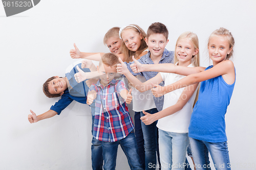 Image of The smiling teenagers showing okay sign on white 