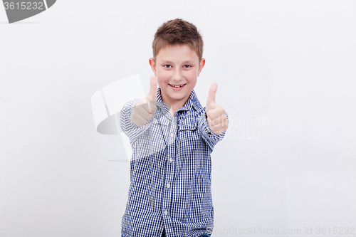 Image of Portrait of happy boy showing thumbs up gesture