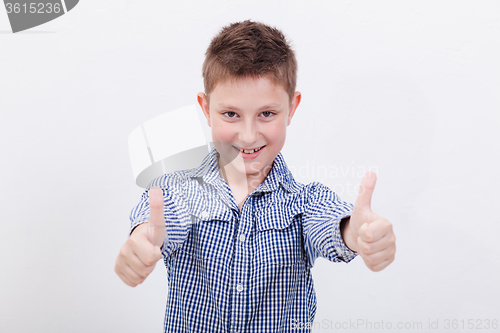 Image of Portrait of happy boy showing thumbs up gesture