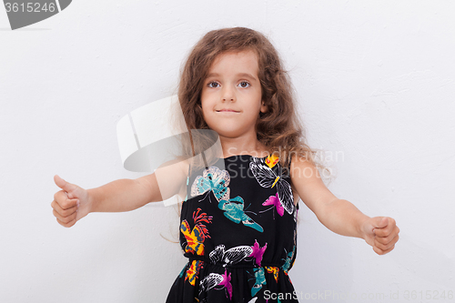 Image of Portrait of a beautiful girl showing thumbs up on white