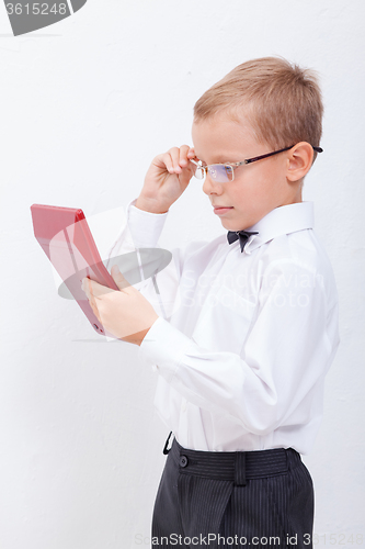 Image of Portrait of teen boy with calculator on white background