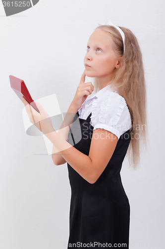 Image of Portrait of teen girl with calculator on white background