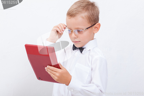 Image of Portrait of teen boy with calculator on white background