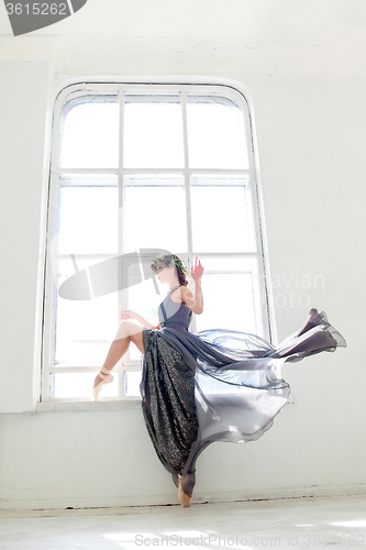 Image of The beautiful ballerina posing in long gray dress 