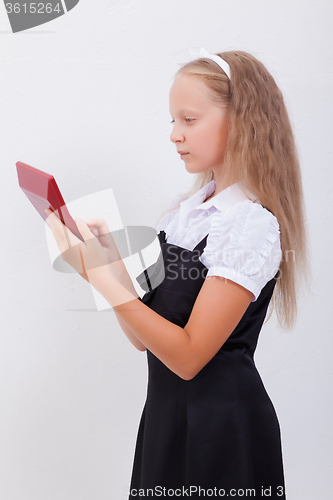 Image of Portrait of teen girl with calculator on white background