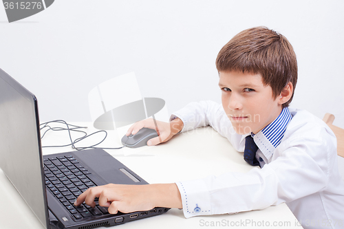 Image of Boy using his laptop computer