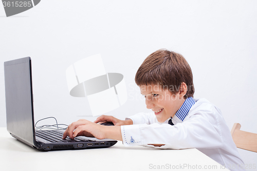 Image of Boy using his laptop computer