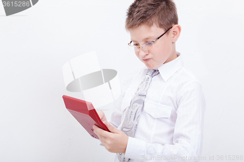 Image of Portrait of teen boy with calculator on white background