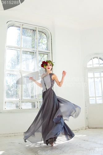 Image of The beautiful ballerina dancing in long gray dress 