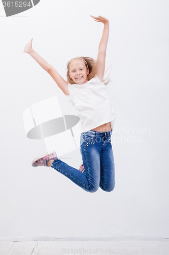 Image of  happy young girl jumping  on white background