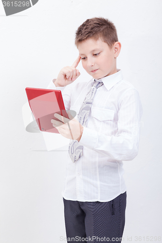 Image of Portrait of teen boy with calculator on white background